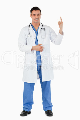 Portrait of a doctor pointing at a copy space