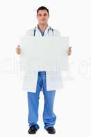 Portrait of a doctor holding a blank panel