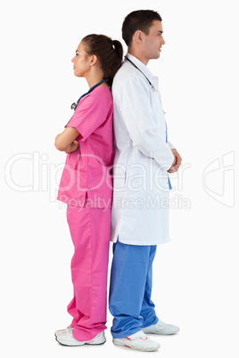 Portrait of a doctor and a nurse posing back to back