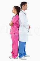 Portrait of a doctor and a nurse posing back to back