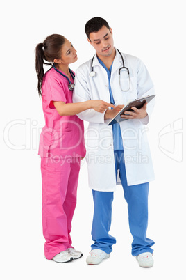 Portrait of a nurse showing something to a doctor