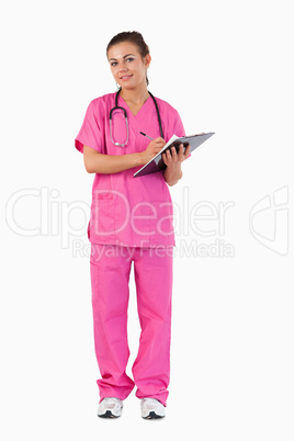 Portrait of a female doctor taking notes Portrait of a female doctor taking notes