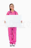 Portrait of a female doctor holding a blank panel