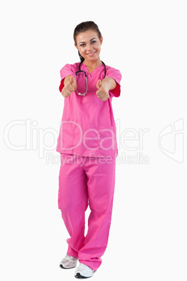 Portrait of a brunette doctor with thumbs up