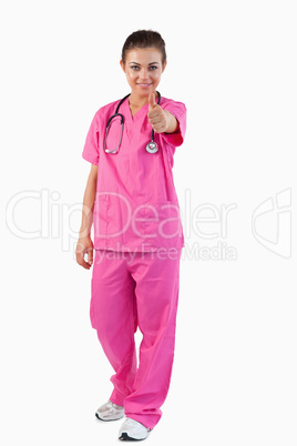 Portrait of a female doctor with thumb up