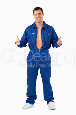Portrait of a handsome mechanic with the thumbs up