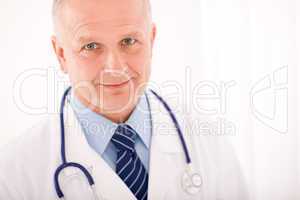 Mature doctor male with stethoscope cross arms