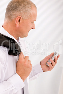 Mature businessman hold phone close-up portrait