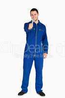 Smiling young mechanic in boiler suit presenting his wrench