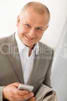Businessman mature smiling hold phone portrait