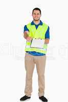 Smiling male in safety jacket handing his notes over