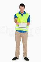 Smiling male in safety jacket passing his notes over