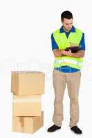 Young delivery man completing delivery note