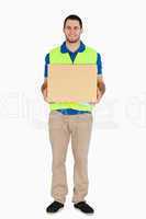Smiling young delivery man carrying a parcel