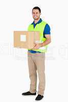 Smiling young delivery man holding a parcel