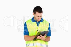Young delivery man filling in bill of delivery