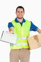 Smiling young delivery man with packet asking for signature