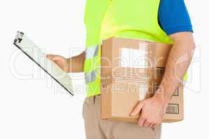 Side view of delivery man with delivery note and parcel