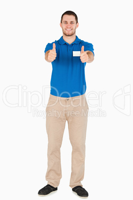 Smiling young sales assistant giving thumbs up