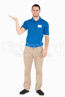 Smiling young salesman presenting in his palm