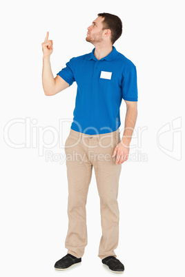 Young salesman looking and pointing upwards