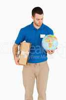 Young salesman with packet and globe in his hands