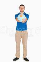 Young salesman presenting globe with his hands