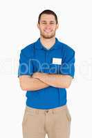 Smiling young salesman with folded arms