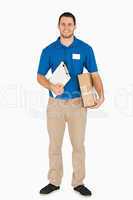 Smiling young salesman with clipboard and parcel