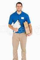 Smiling young salesman with packet and clipboard