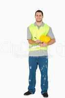Smiling young construction worker with clipboard