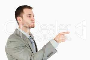 Side view of young businessman using futuristic touchscreen