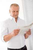 Senior businessman happy read newspapers portrait