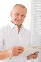 Senior businessman happy read newspapers portrait