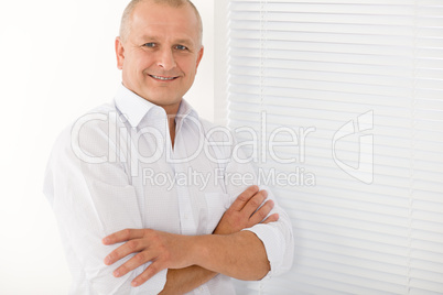 Mature businessman smile cross arms posing