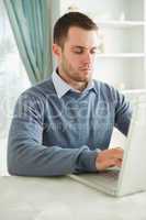 Businessman working on his laptop in his home office