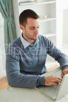 Businessman typing on his laptop in his homeoffice