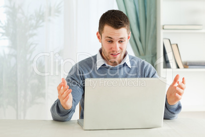 Businessman clueless about his laptop in his homeoffice