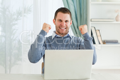 Businessman celebrating success in his homeoffice