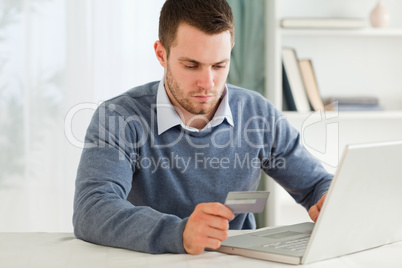 Male entering credit card information in his notebook