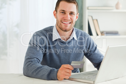 Male with credit card at his laptop