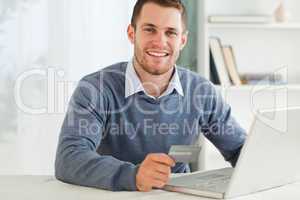 Male with credit card at his laptop