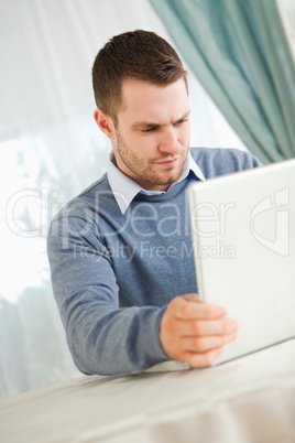 Businessman reading on his laptop