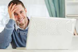 Smiling businessman tired in his homeoffice