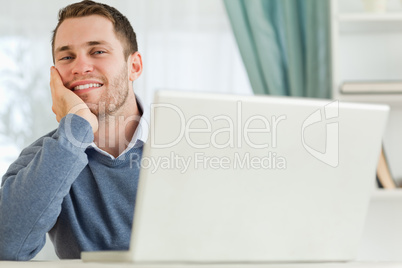 Businessman smiling tired in his homeoffice