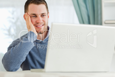 Smiling man on his laptop