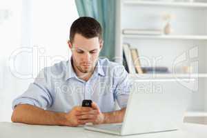Businessman texting in his homeoffice