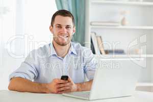Young businessman typing text message in his homeoffice