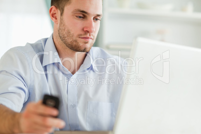 Businessman with cellphone and notebook