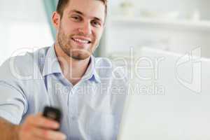 Businessman with laptop and cellphone